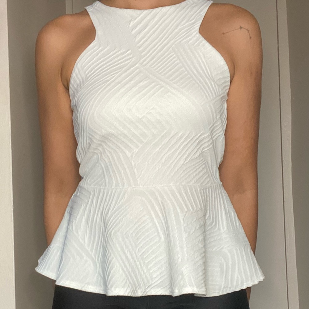 Sleeveless white peplum top